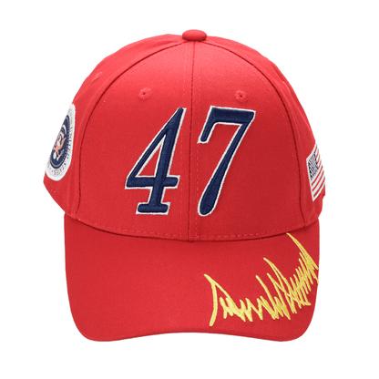 Red Trump 47 Cap with embroidered number 47, yellow signature on bill, presidential seal on left, USA flag on right, and adjustable strap