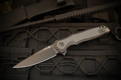 Spartan Blades POROS folding knife with 154CM blade and carbon fiber G-10 handle in tactical setting